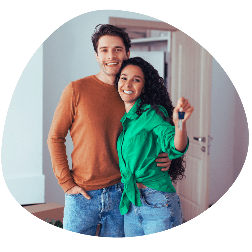 happy young couple with keys to their new house