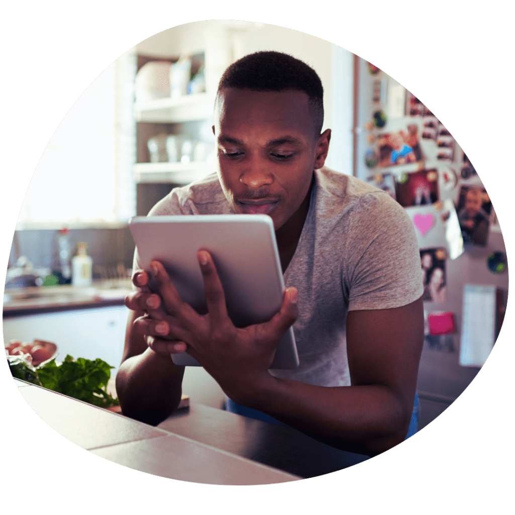 man on tablet in kitchen